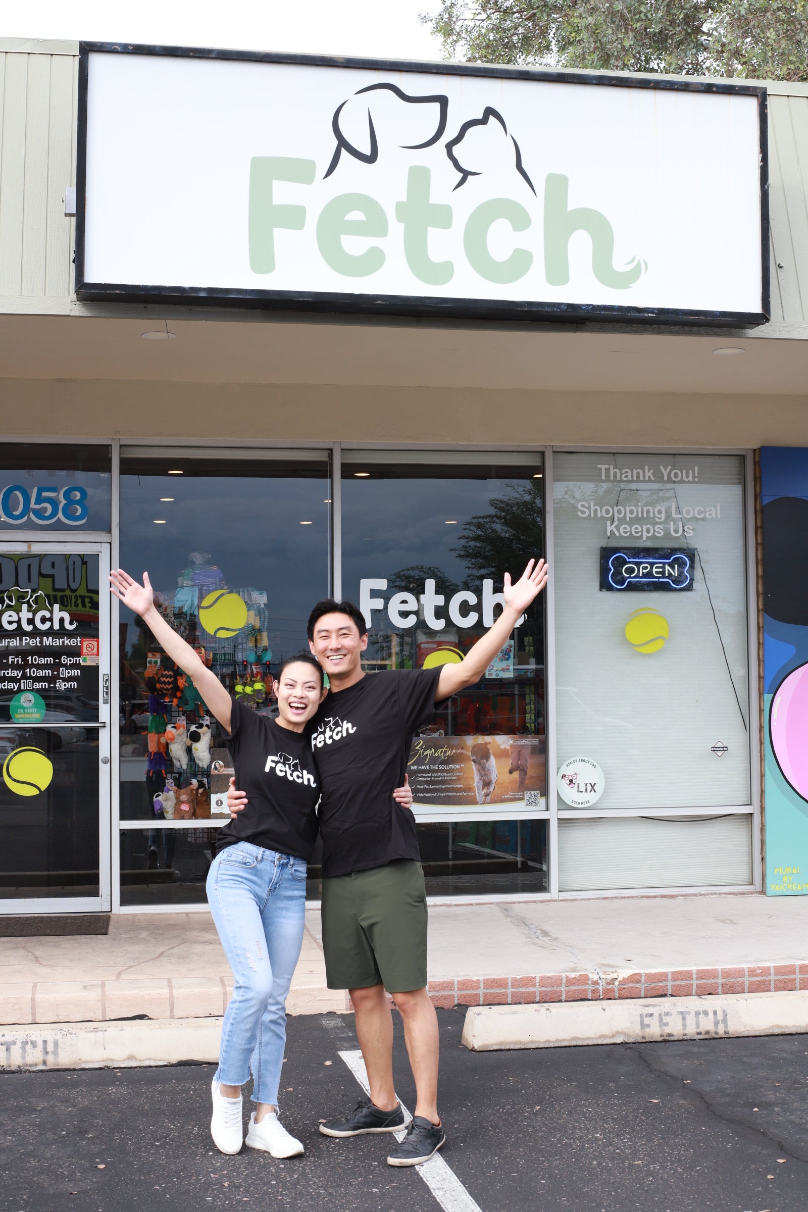 Two people standing outside a store with 'Fetch' branding.